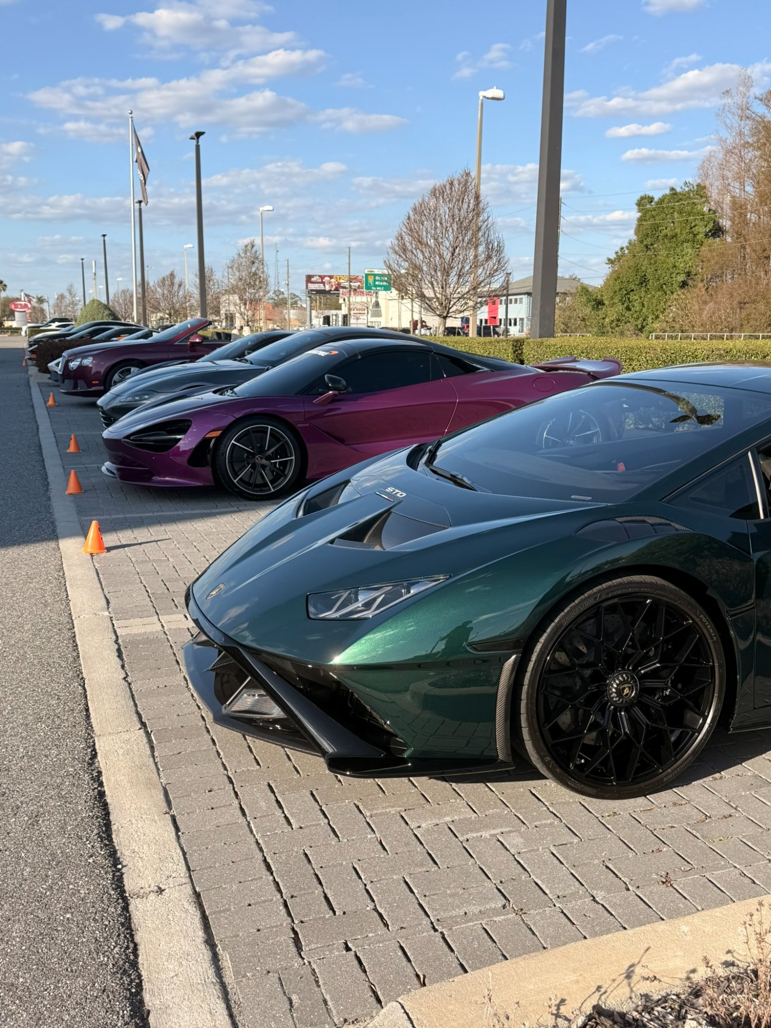 Lamborghini Huracán STO and exotic car lineup at Wheels Watches Whiskey Wine